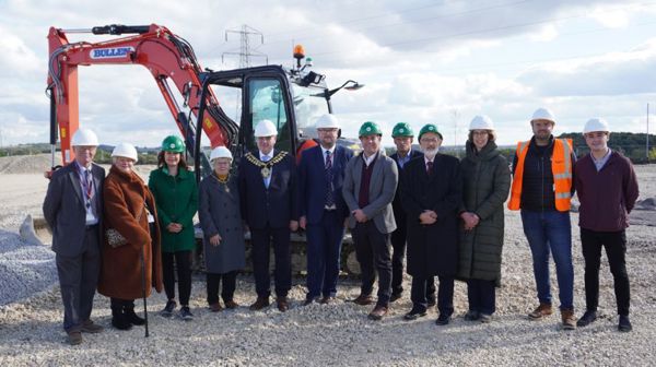 People stood in front of a digger at The Parkside Centre In Hoyland Common