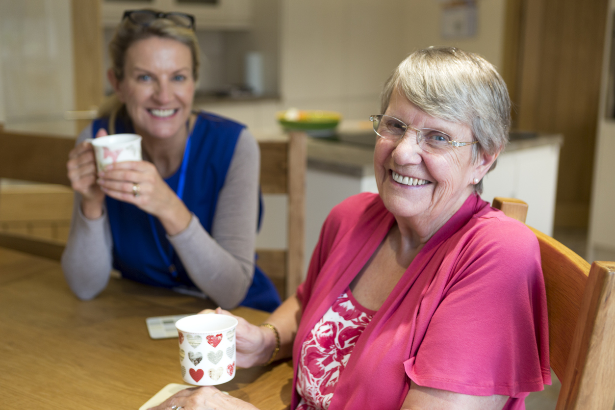 Carer and resident drinking tea Carer and resident drinking tea