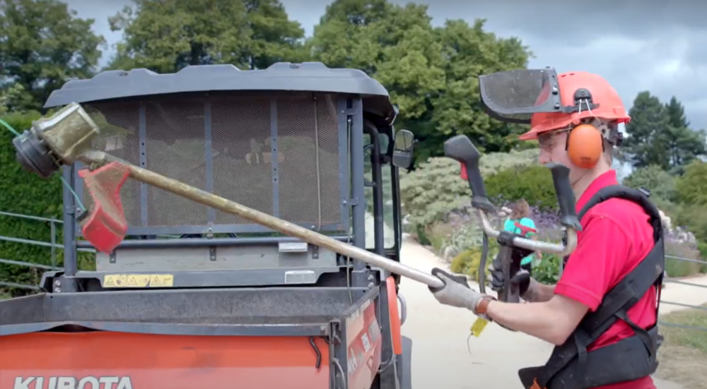Man working with grass cutting strimmer Man working with grass cutting strimmer