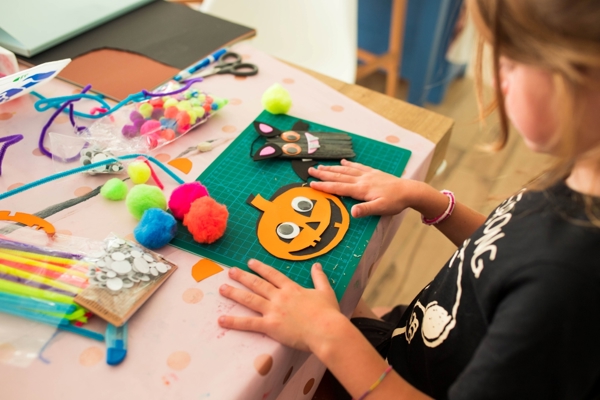 A girl enjoying pumpkin crafts for Halloween