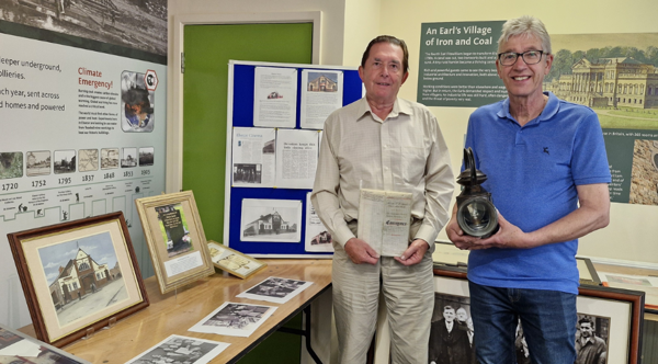 Two people standing in front of a display in the Visitor Centre at Elsecar Heritage Centre