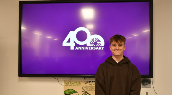 A student from Barnsley College showing his new Worsbrough Mill 400 Anniversary Logo