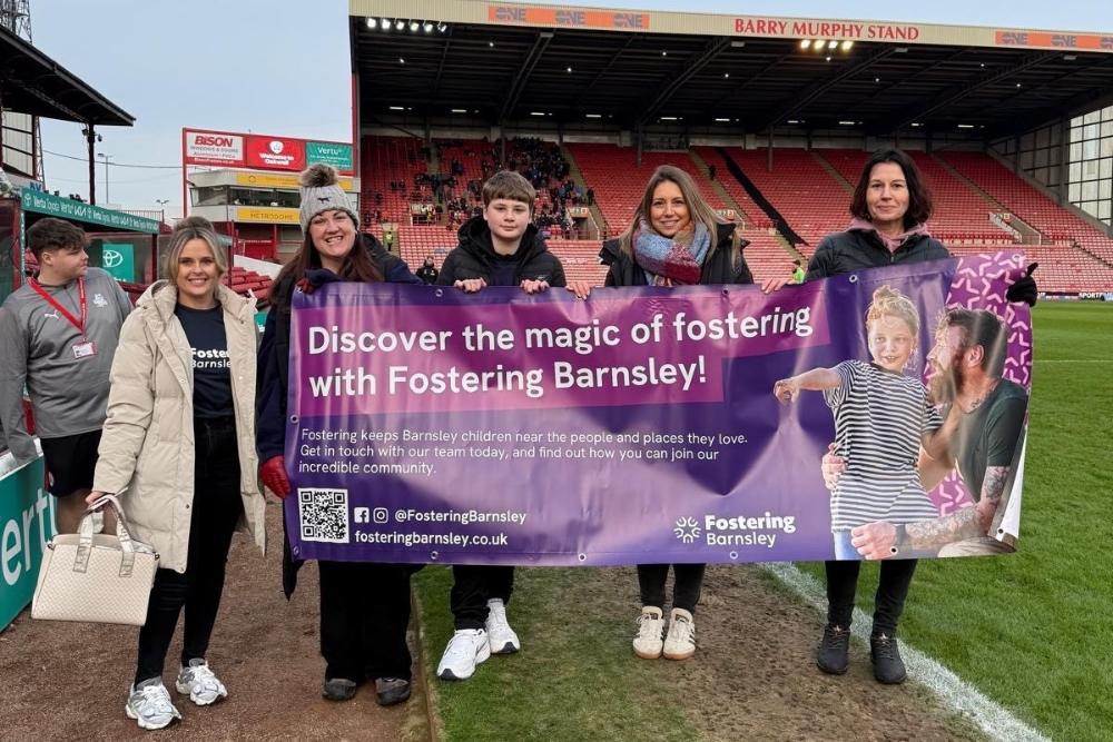 Fostering Barnsley Team Holding A Banner At Oakwell Stadium Fostering Barnsley Team Holding A Banner At Oakwell Stadium