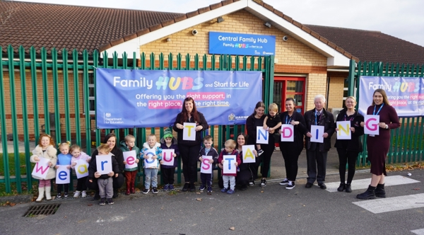 Group Of People Standing Outside The Central Family Hub