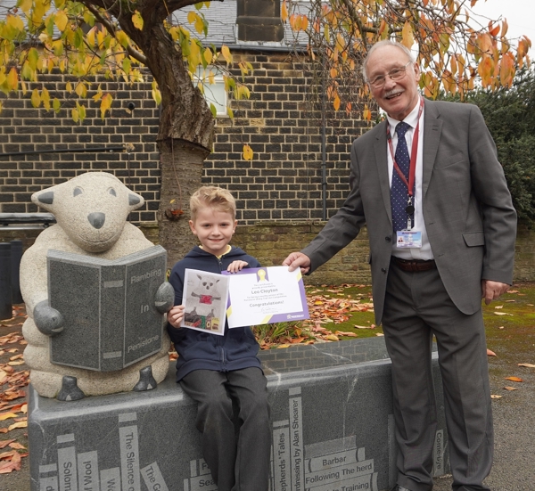 Penistone Sheep Trail Competition winner Leo Clayton with Councillor Robin Franklin with the scupture of a sheep reading a book